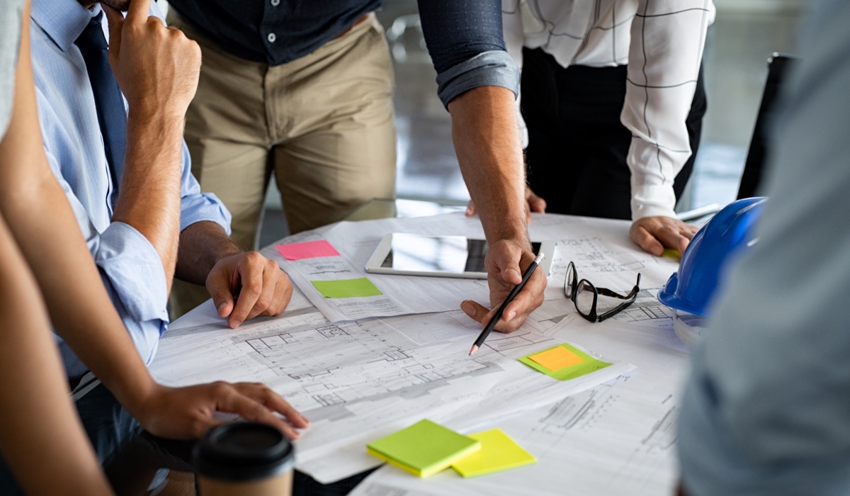 Equipe de arquitetos colaborando em um projeto de construção.